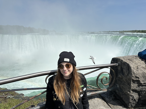 A woman sitting in front of Niagara Falls